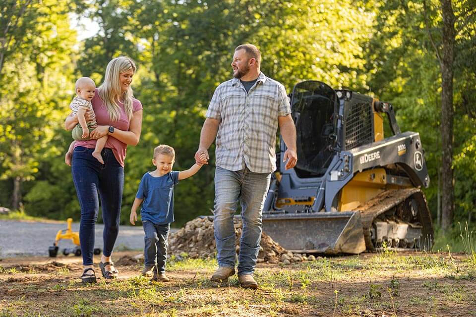 Ryan and Brittany Richmond Ryan and Brittany Richmond walking with their children on their land.