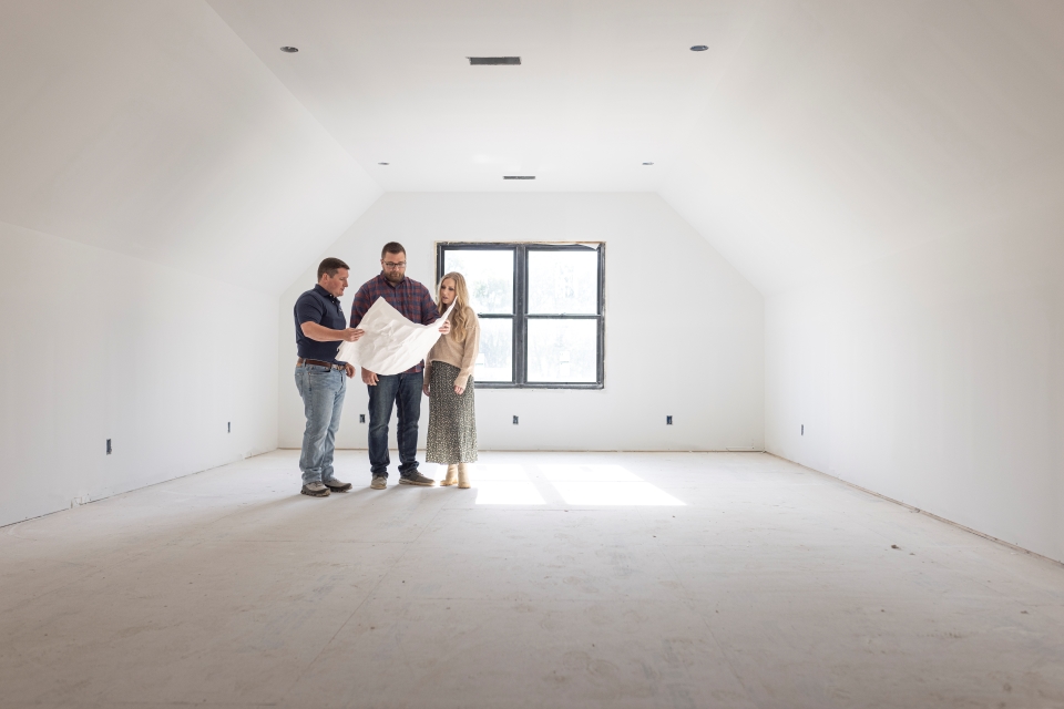 Morris Family Review Blueprints with Loan Officer