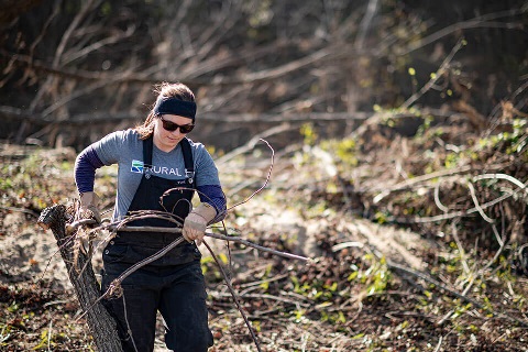 A Rural 1st team member helps clear debris in Tennessee after Hurricane Helene.