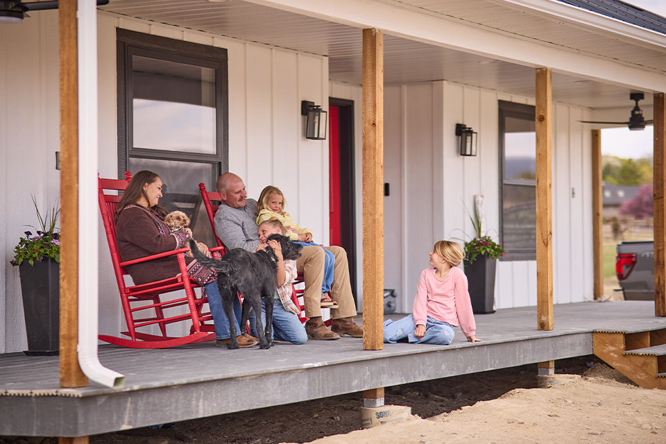Rural1st_2026_0327_Website_StoryBodyImage_960x640_EricAndNicole_FINAL Rural 1st customers sit on front porch of construction project in western Colorado