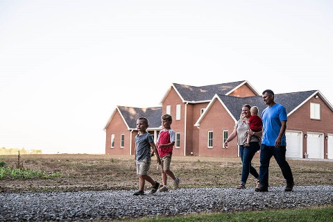 Ohio family walk on driveway of rural home construction financed by Rural 1st