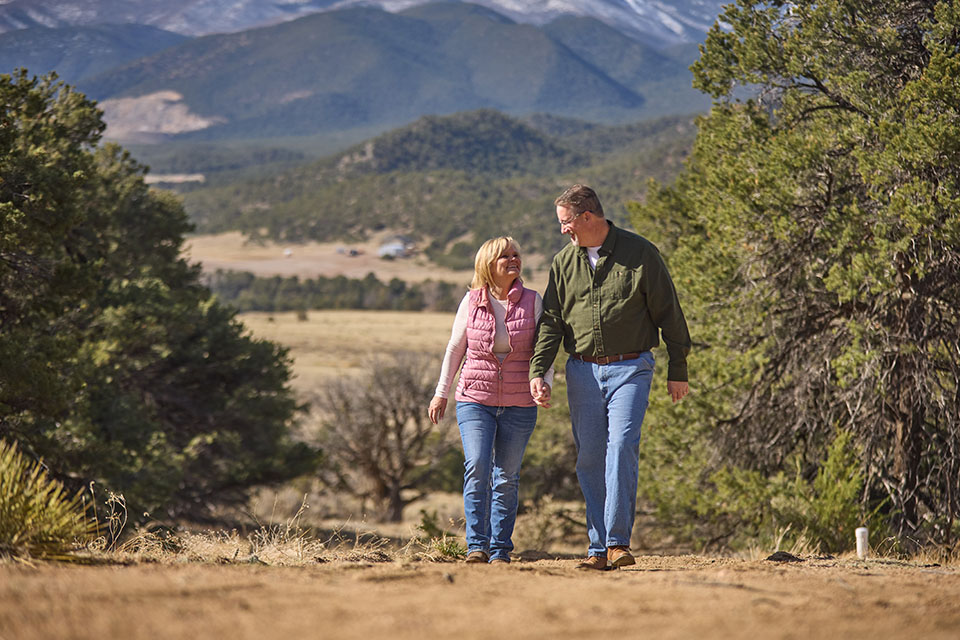 Couple walks on construction site in rural Colorado financed by Rural 1st.