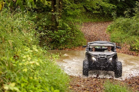 Man and woman ride ATV on land financed by Rural 1st