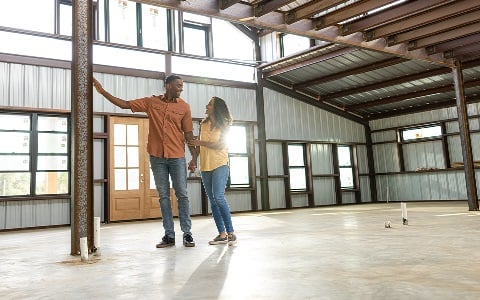 A couple inside their under construction barndo.