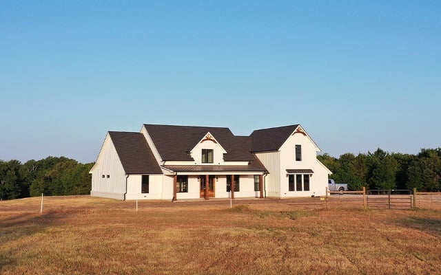 A newly constructed rural home on a big plot of land.