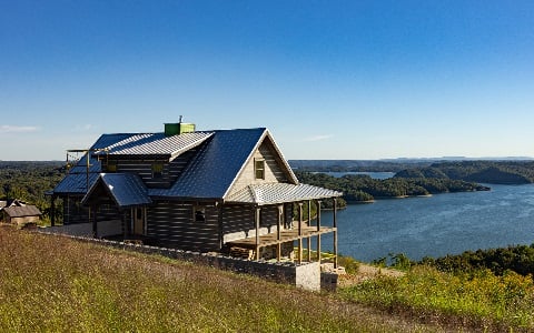 A newly-remodeled rural home looking out onto a lake.